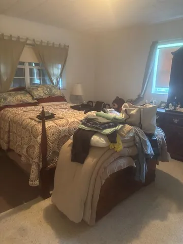 a bathroom with a granite countertop toilet sink and mirror