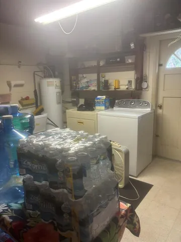 a room with furniture a rug and white walls