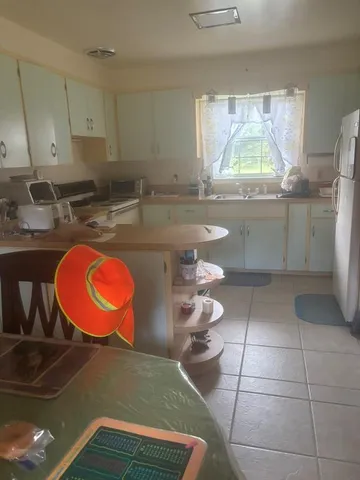 a view of a kitchen with a sink and cabinets