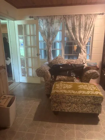 an empty room with windows and wooden floor