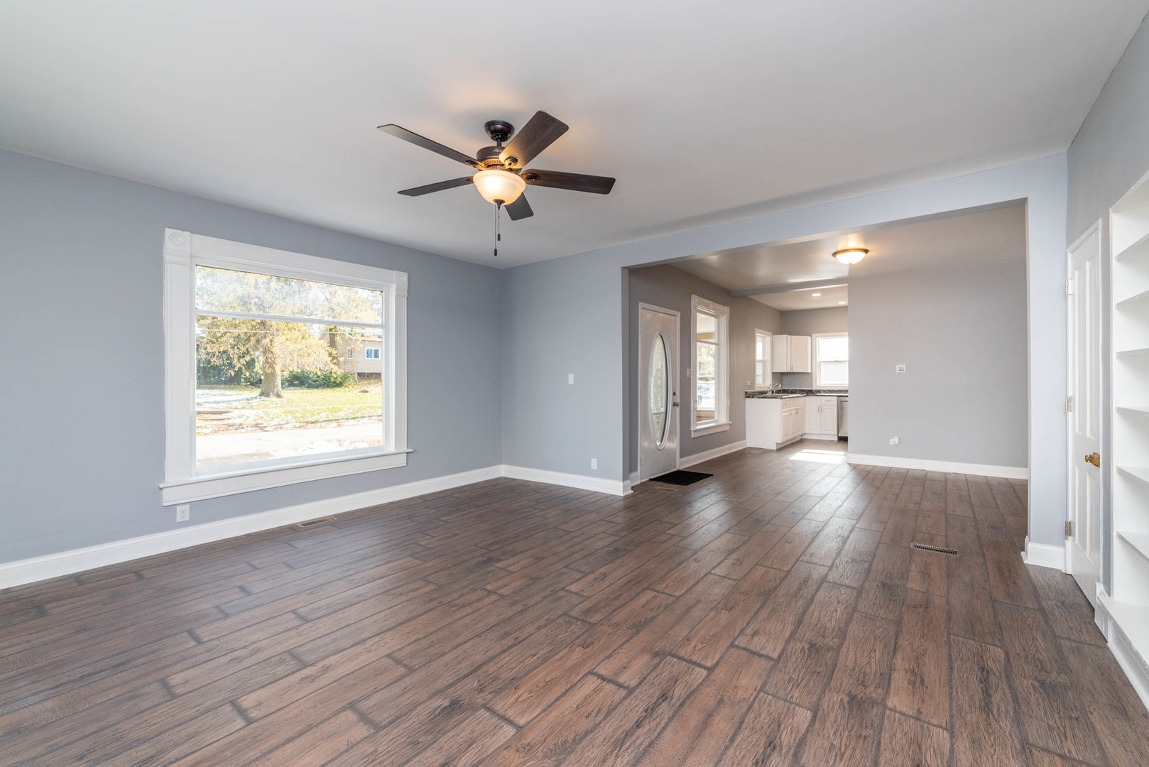 404 Garfield Road Harvard, IL 60033 - Photo 13 of 30 a view of an empty room with a window and wooden floor