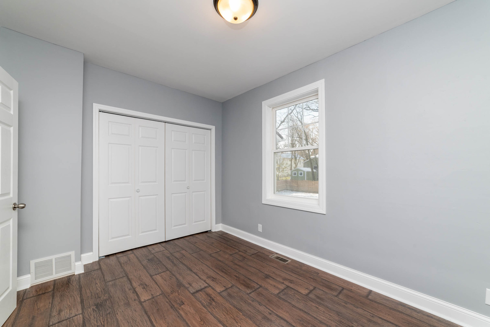 404 Garfield Road Harvard, IL 60033 - Photo 21 of 30 an empty room with wooden floor and windows