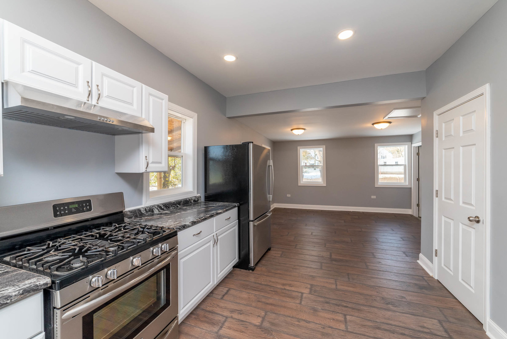 404 Garfield Road Harvard, IL 60033 - Photo 4 of 30 a kitchen with stainless steel appliances granite countertop a stove and a refrigerator