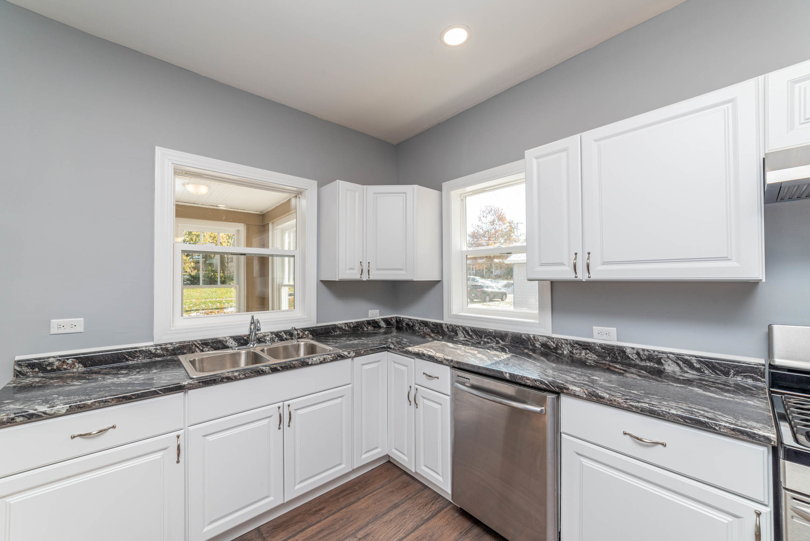 404 Garfield Road Harvard, IL 60033 - Photo 5 of 30 a kitchen with granite countertop white cabinets sink and window