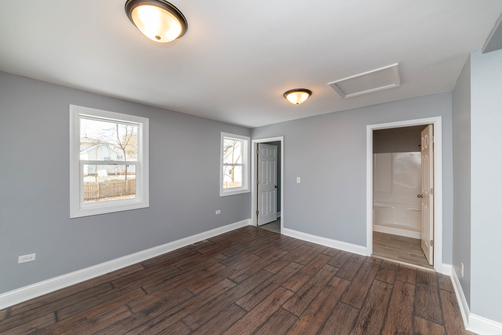 404 Garfield Road Harvard, IL 60033 - Photo 10 of 30 an empty room with wooden floor and windows