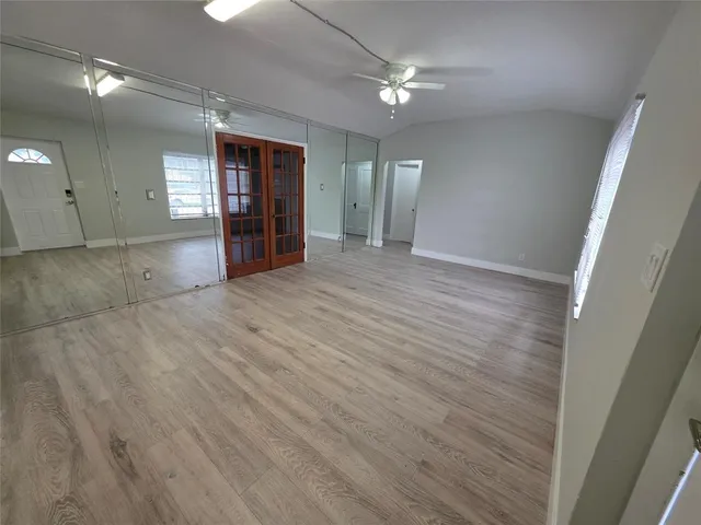 wooden floor in an empty room with a window