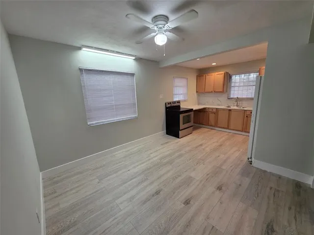 a view of workspace with wooden floor and ceiling fan