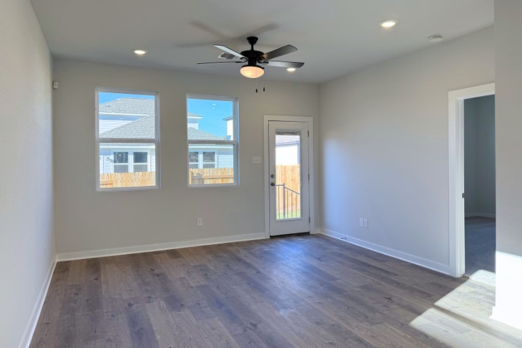 213 Firefox Way Jarrell, TX 76537 - Photo 3 of 12 a view of an empty room with wooden floor and a window