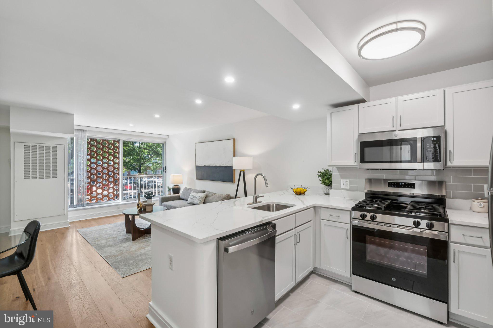 a kitchen with a sink stove and microwave