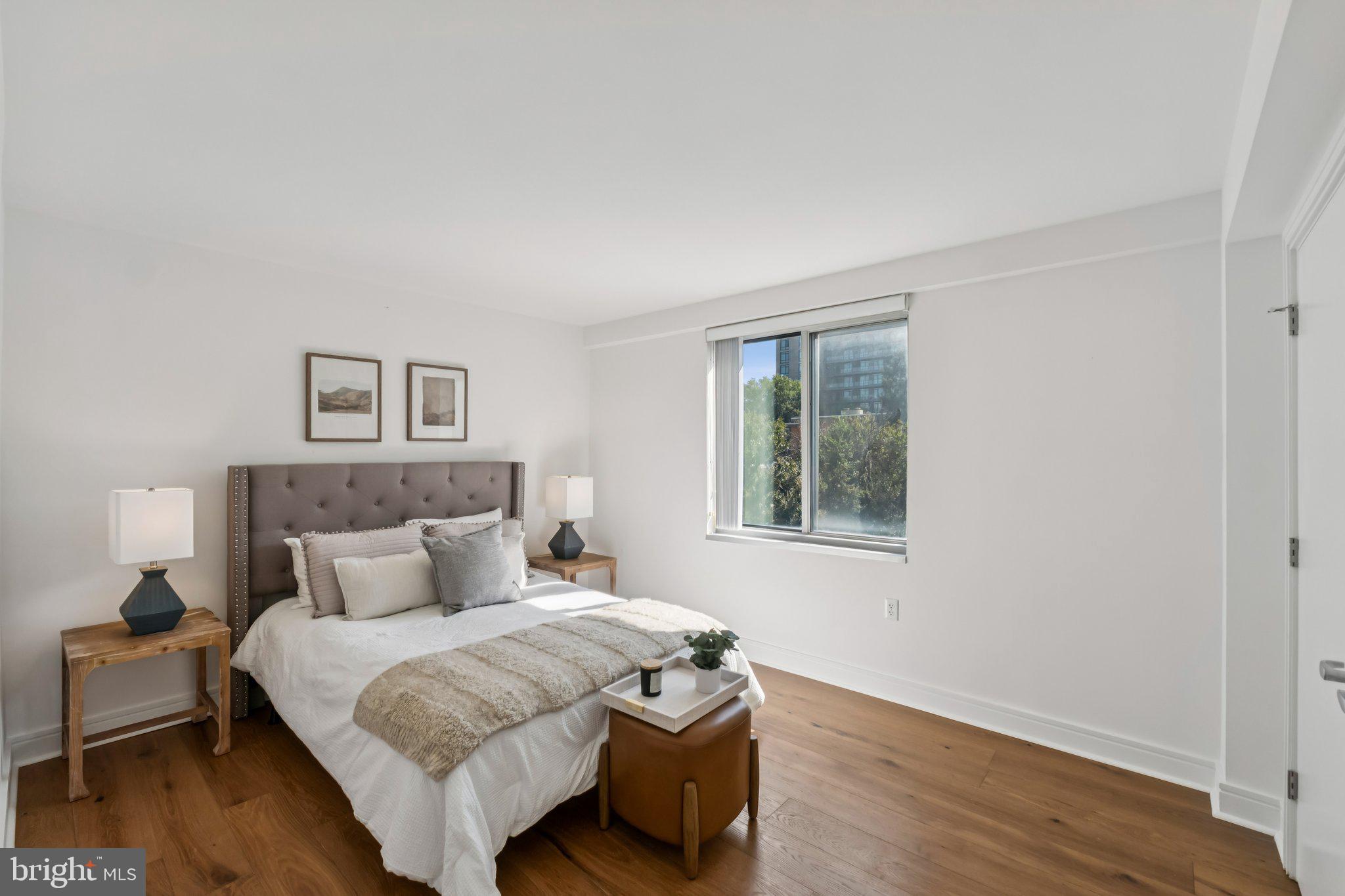 800 4th Street Southwest, Unit 121S Washington, DC 20024 - Photo 11 of 23 a bedroom with a bed and wooden floor
