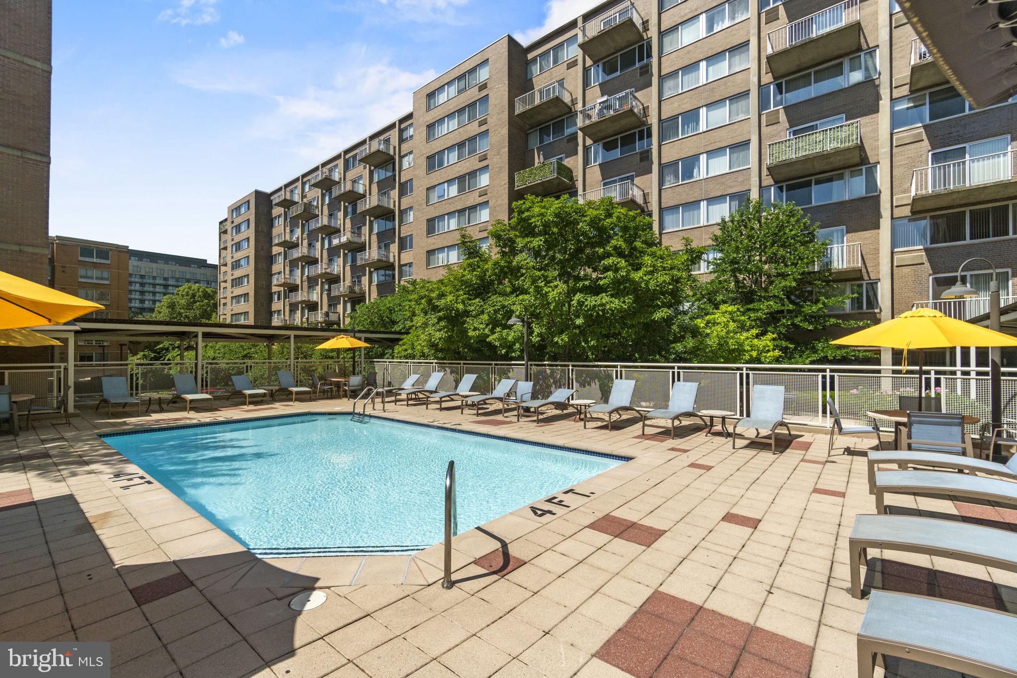 800 4th Street Southwest, Unit 121S Washington, DC 20024 - Photo 15 of 23 a view of a swimming pool with a lounge chairs