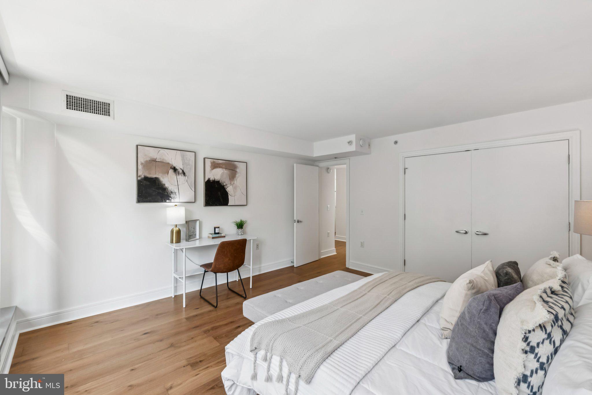 800 4th Street Southwest, Unit 121S Washington, DC 20024 - Photo 10 of 23 a bedroom with a bed and a table in it