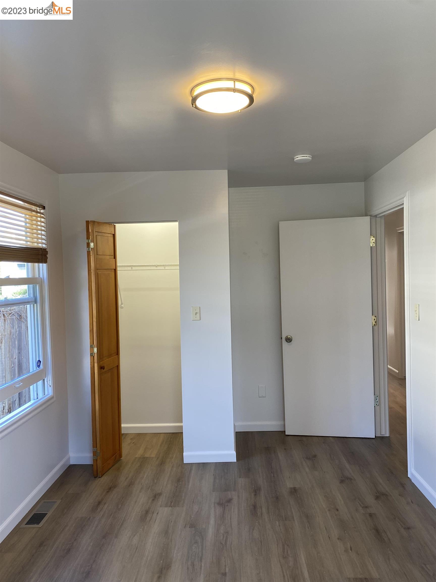 Rockridge Oakland, CA 94609 - Photo 12 of 31 an empty room with wooden floor and windows