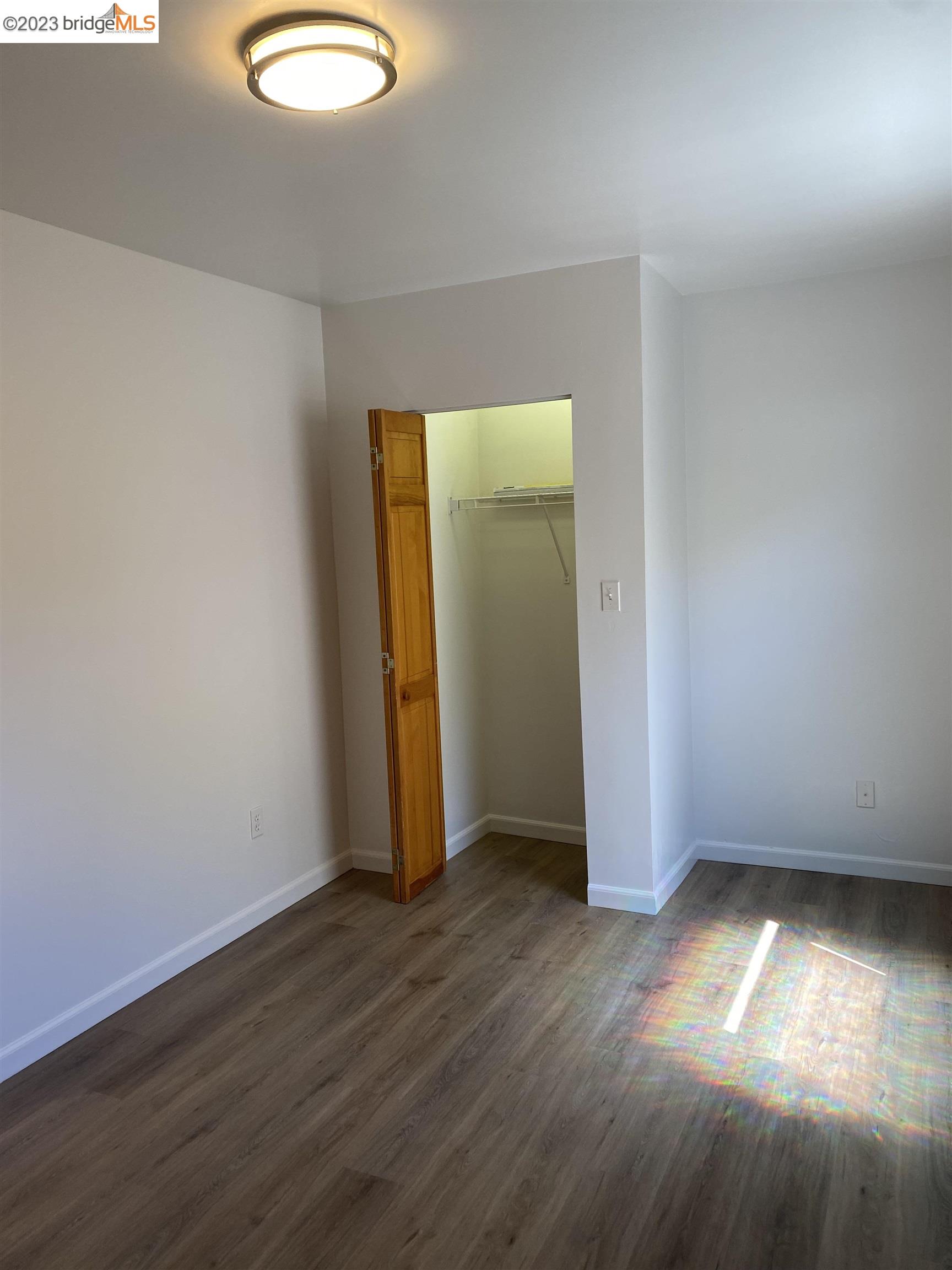 Rockridge Oakland, CA 94609 - Photo 13 of 31 an empty room with wooden floor and windows