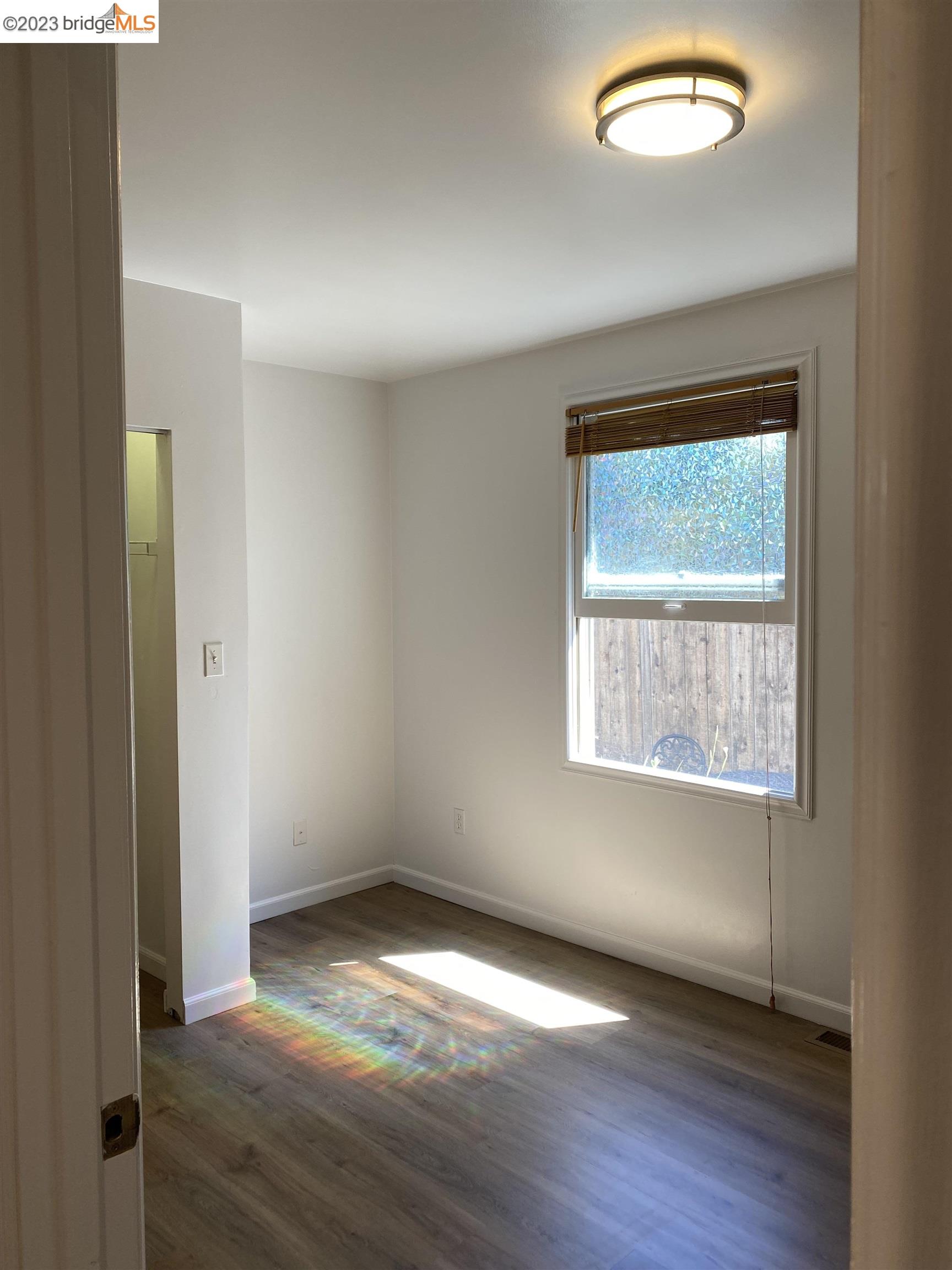 Rockridge Oakland, CA 94609 - Photo 15 of 31 an empty room with wooden floor and windows