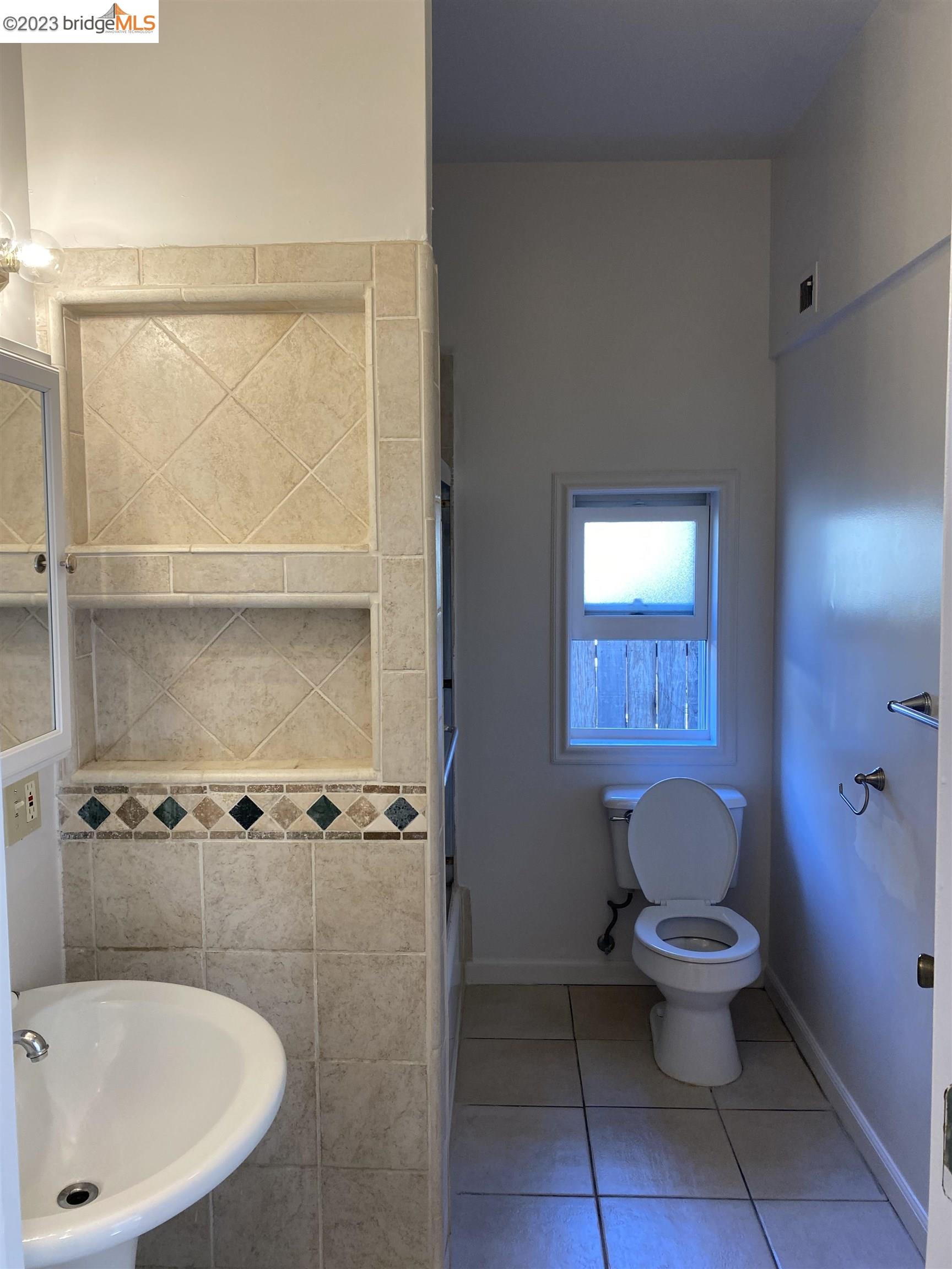 Rockridge Oakland, CA 94609 - Photo 21 of 31 a white toilet sitting next to a bathroom sink