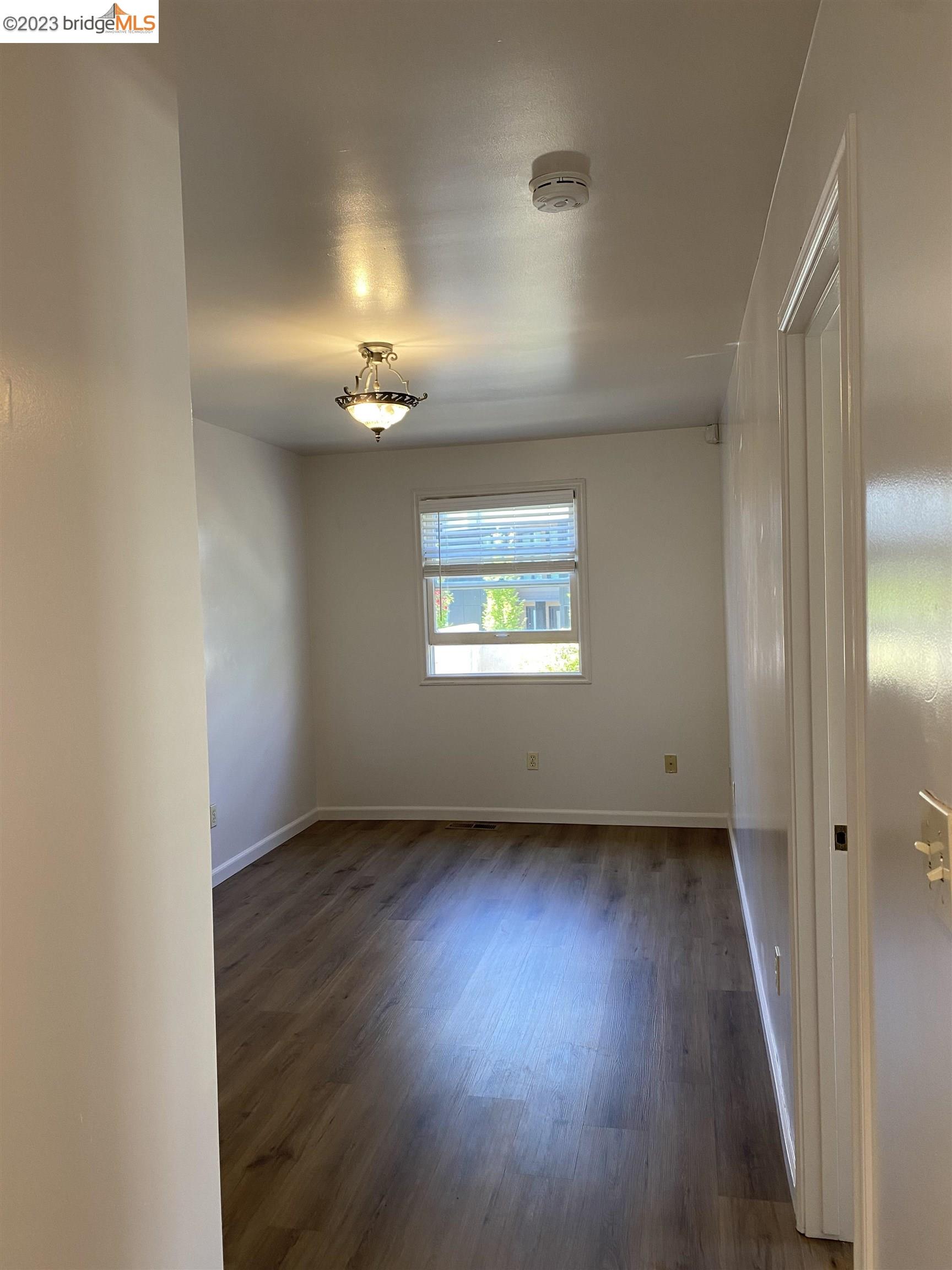 Rockridge Oakland, CA 94609 - Photo 10 of 31 an empty room with wooden floor cabinet and windows