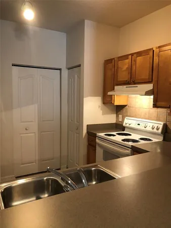 a kitchen with a sink and cabinets