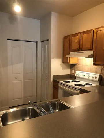 a kitchen with a sink and cabinets