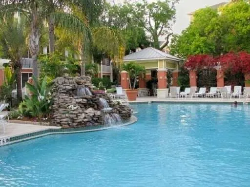 a front view of a house with garden and sitting area