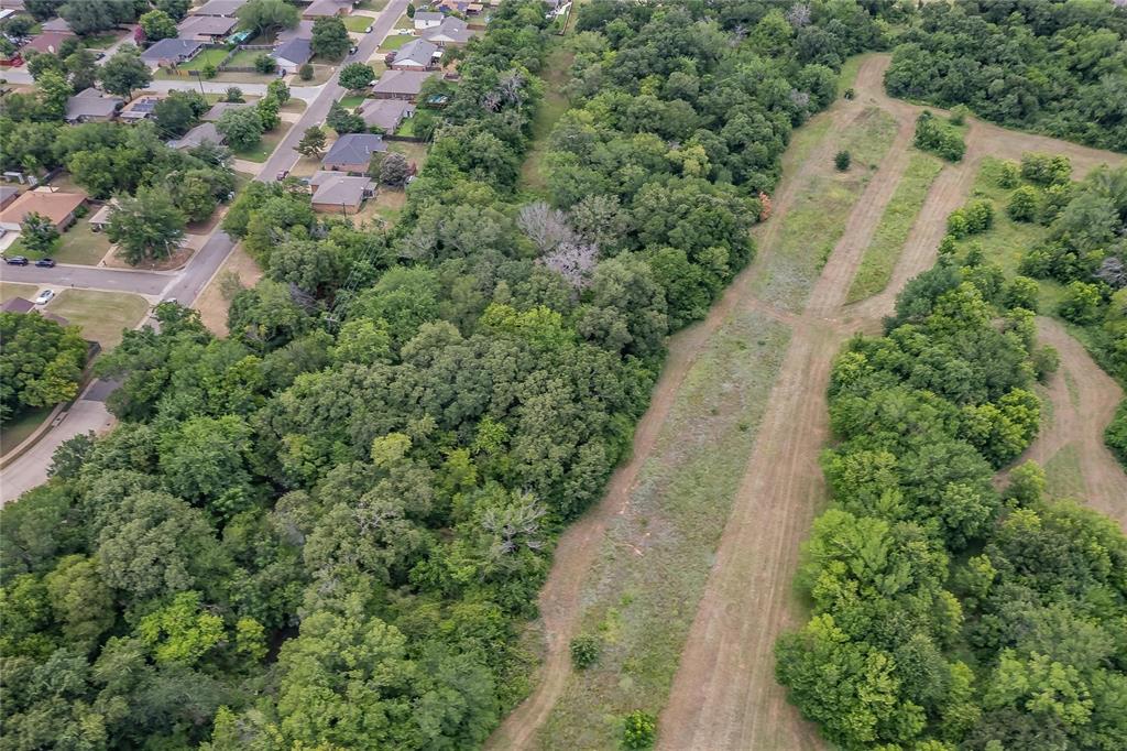 4001 Curry Road Arlington, TX 76001 - Photo 13 of 31 an aerial view of a house with a yard and trees all around