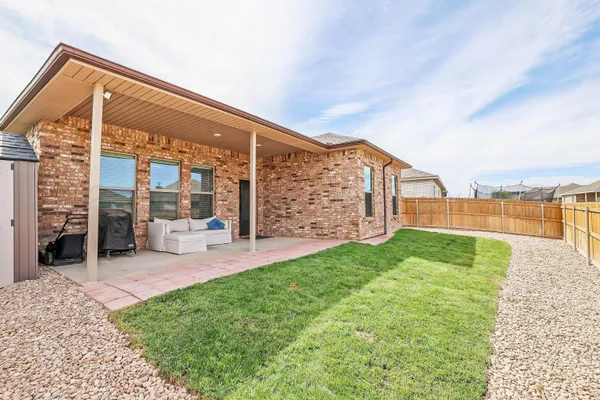 a view of a house with backyard and porch
