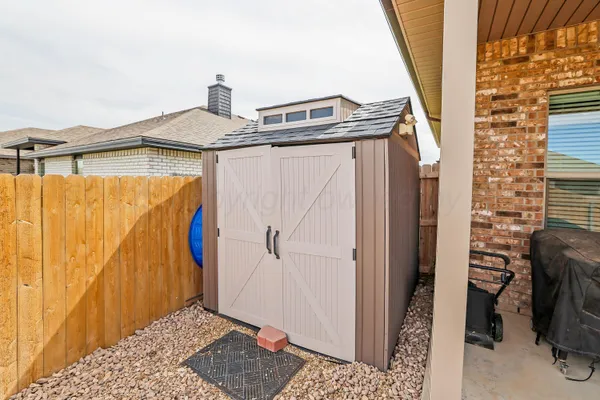 a kitchen with stainless steel appliances granite countertop a table chairs sink refrigerator and microwave