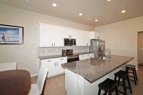 a living room with furniture and kitchen view