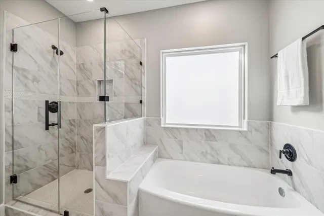 a bathroom with a bathtub and shower