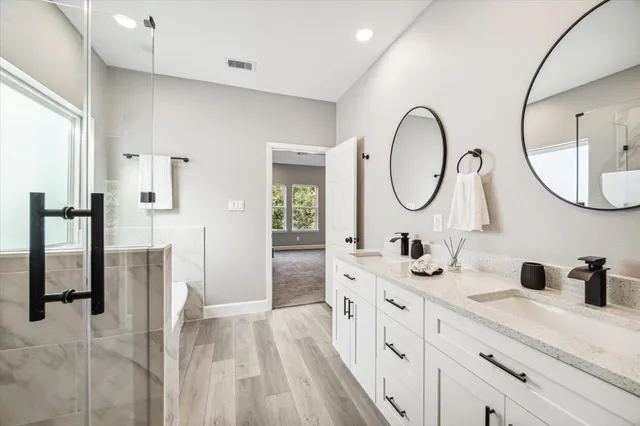 a spacious bathroom with a double vanity sink and a mirror