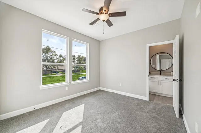 a view of a livingroom with a ceiling fan and window