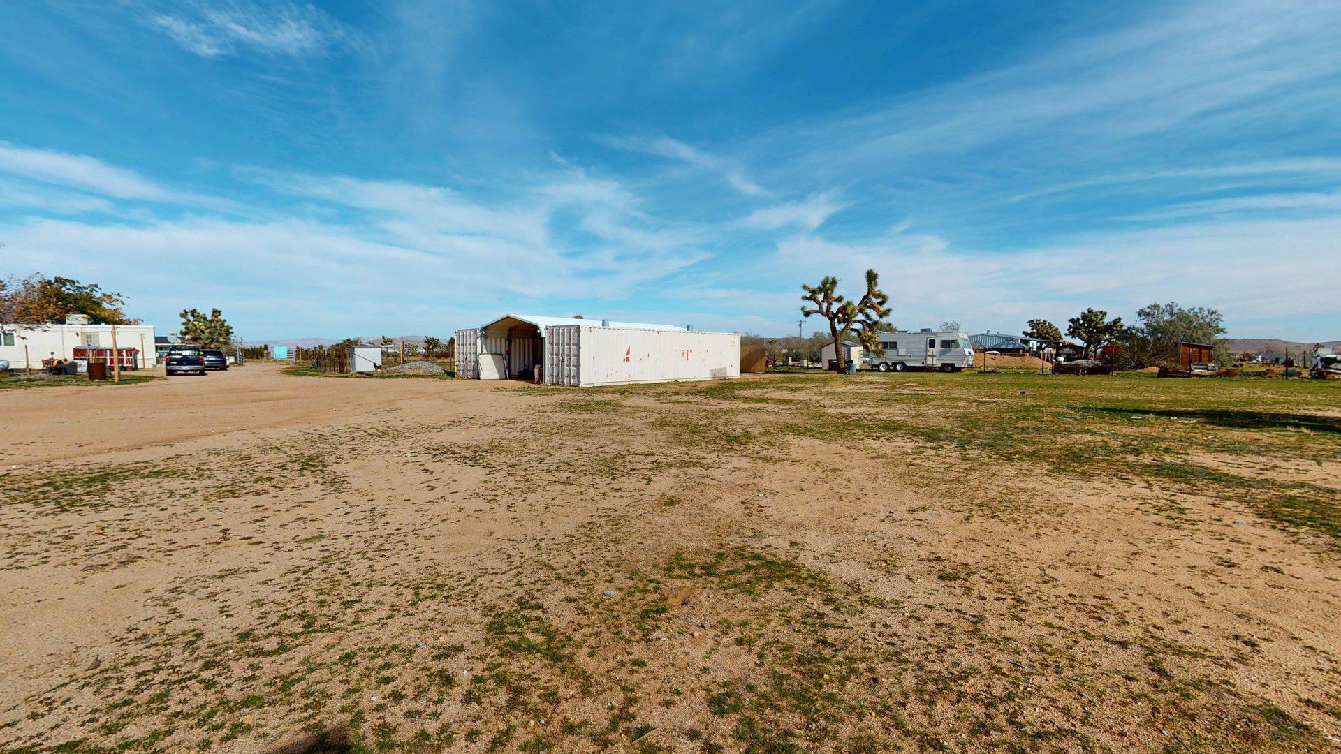 57775 Junipero Trail Yucca Valley, CA 92284 - Photo 14 of 19 a view of a large tree in front of a house