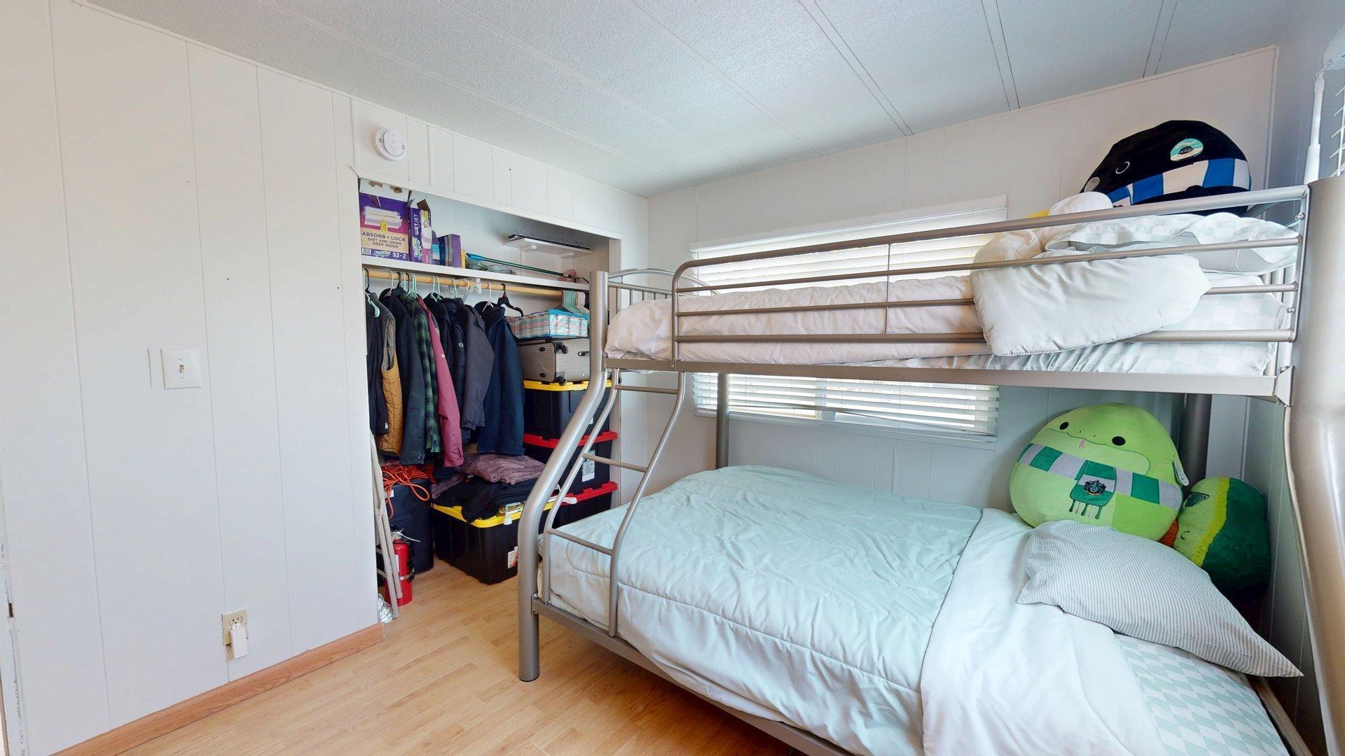 57775 Junipero Trail Yucca Valley, CA 92284 - Photo 2 of 19 a bed room with a bed and a book shelf