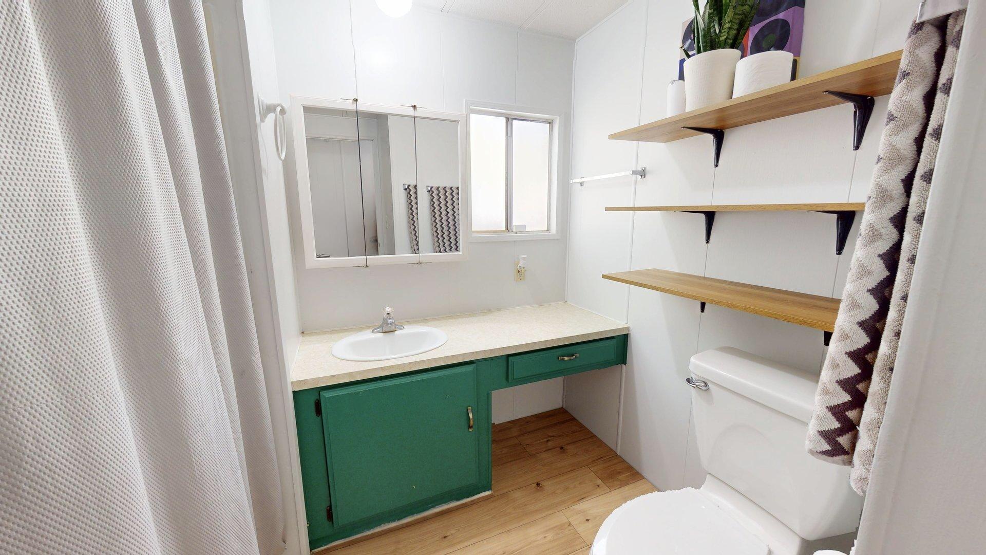57775 Junipero Trail Yucca Valley, CA 92284 - Photo 4 of 19 a bathroom with a sink toilet and mirror
