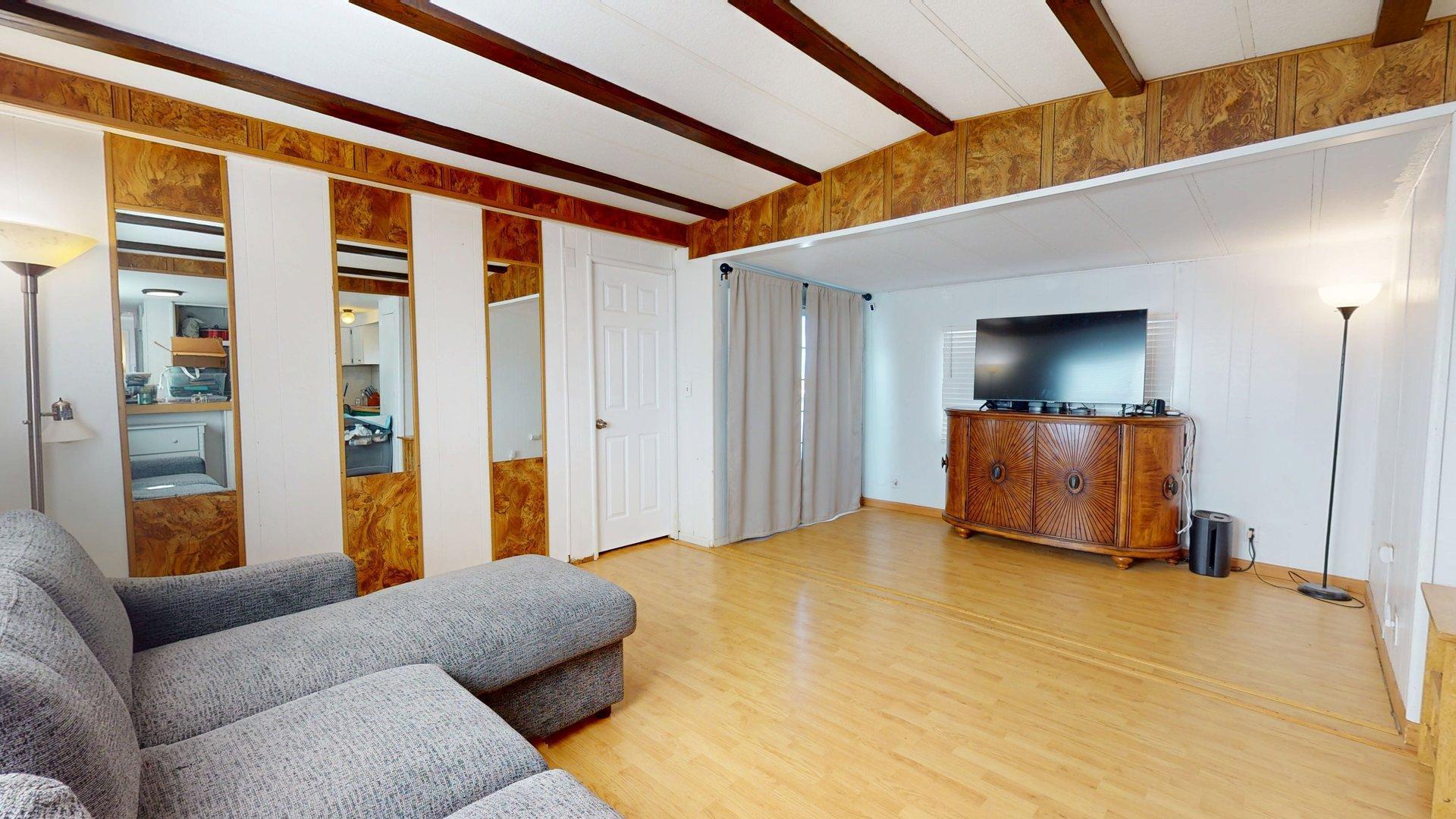 57775 Junipero Trail Yucca Valley, CA 92284 - Photo 7 of 19 a bedroom with a bed and wooden floor