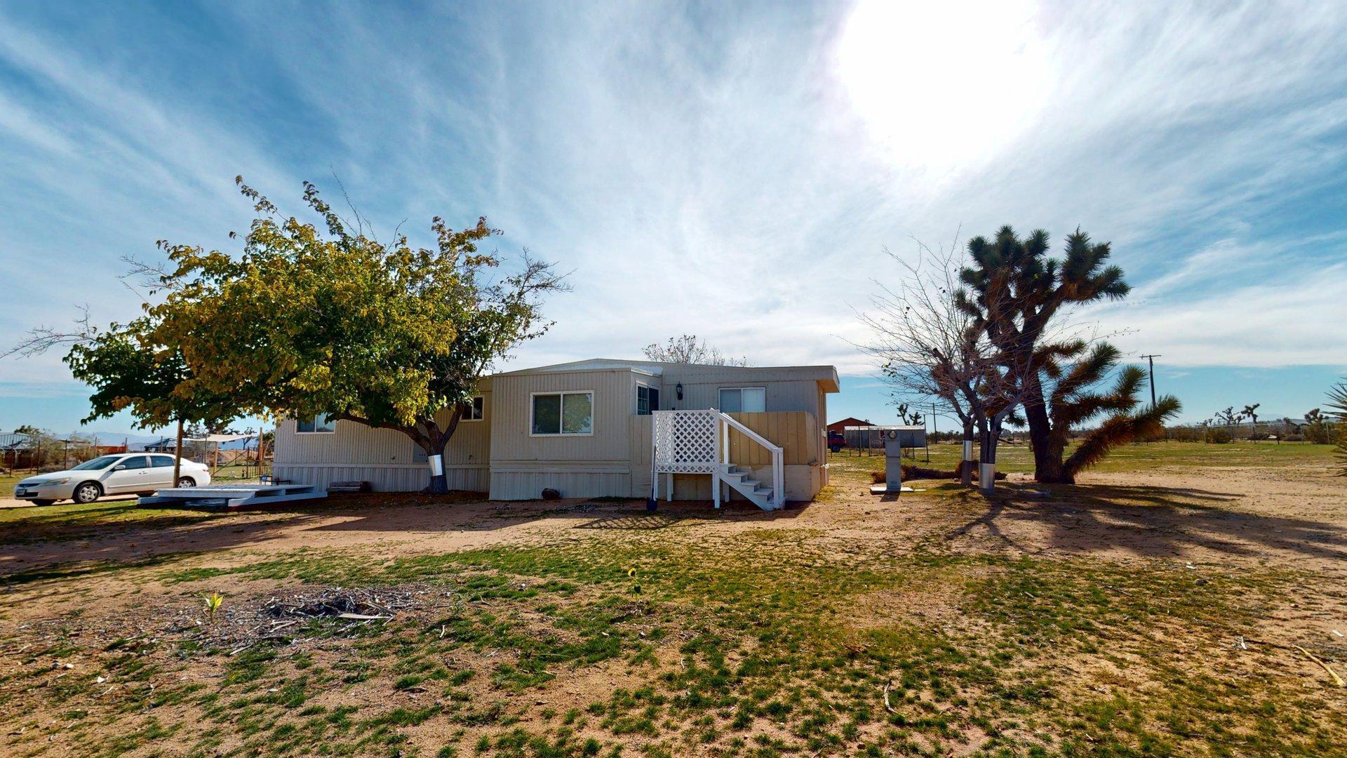 57775 Junipero Trail Yucca Valley, CA 92284 - Photo 9 of 19 a view of a house with a yard