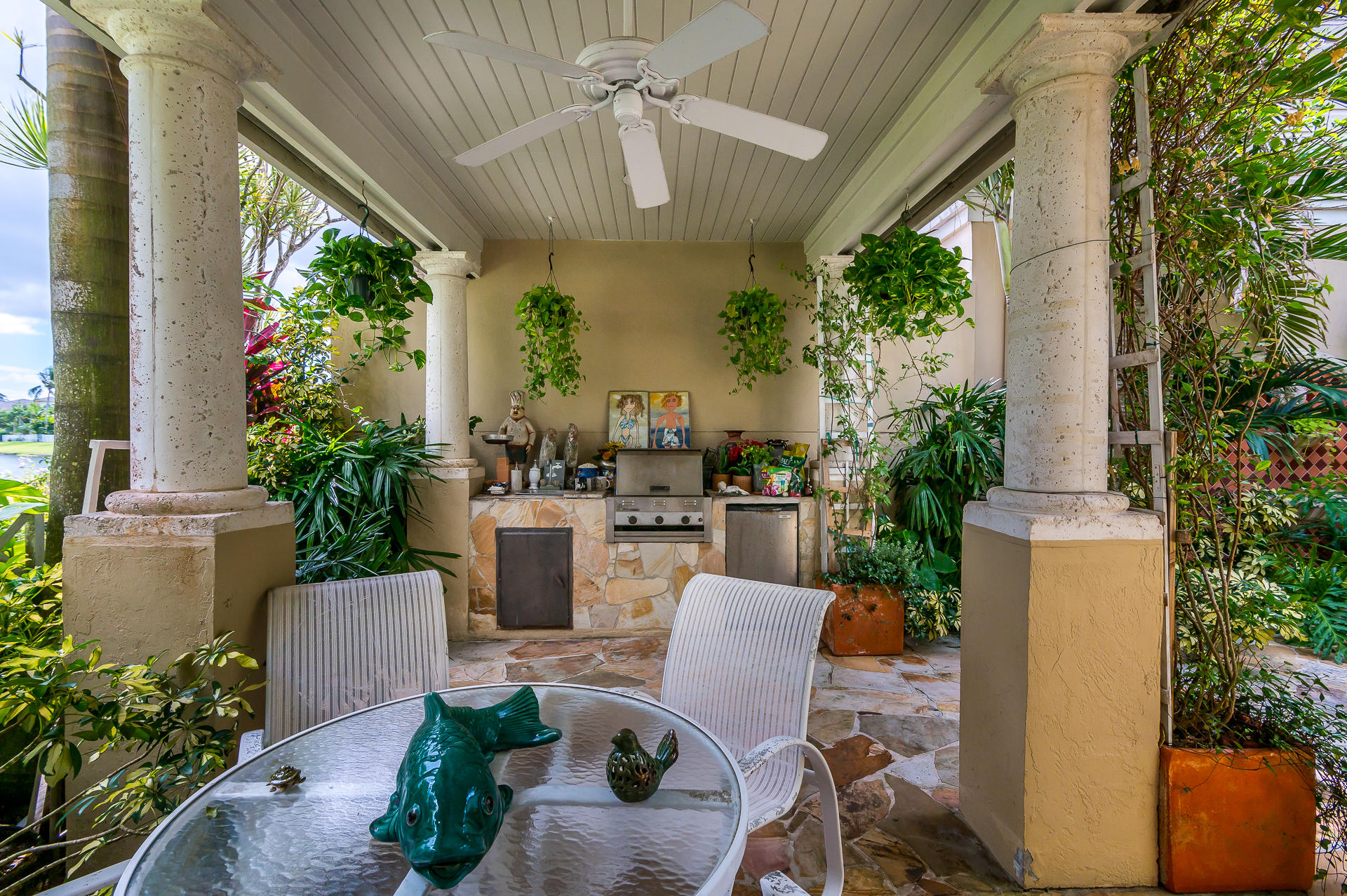 3903 Northwest 58th Street, Unit 38 Boca Raton, FL 33496 - Photo 23 of 30 a view of a patio with plants and chairs potted plants