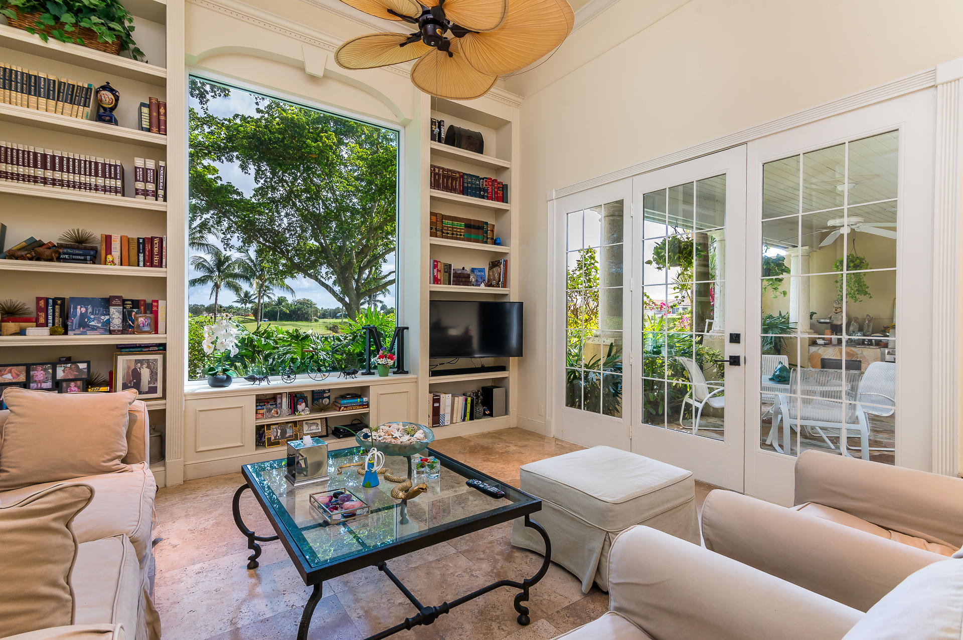 3903 Northwest 58th Street, Unit 38 Boca Raton, FL 33496 - Photo 6 of 30 a living room with furniture a flat screen tv and a floor to ceiling window