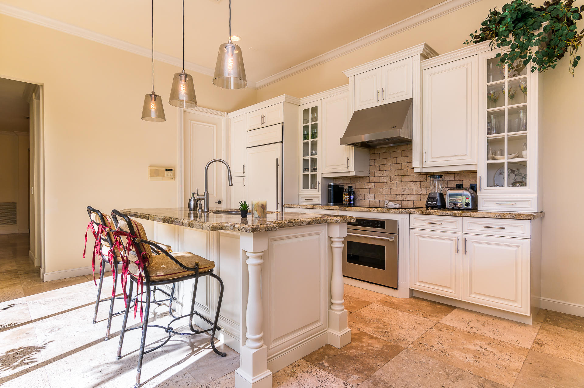 3903 Northwest 58th Street, Unit 38 Boca Raton, FL 33496 - Photo 10 of 30 a kitchen with stainless steel appliances kitchen island granite countertop a table chairs in it and wooden floors