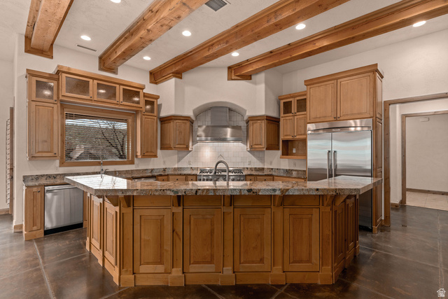2464 East Granite Way St. George, UT 84790 - Photo 47 of 106 Kitchen with glass insert cabinets, finished concrete flooring, backsplash, a large island with sink, and recessed lighting