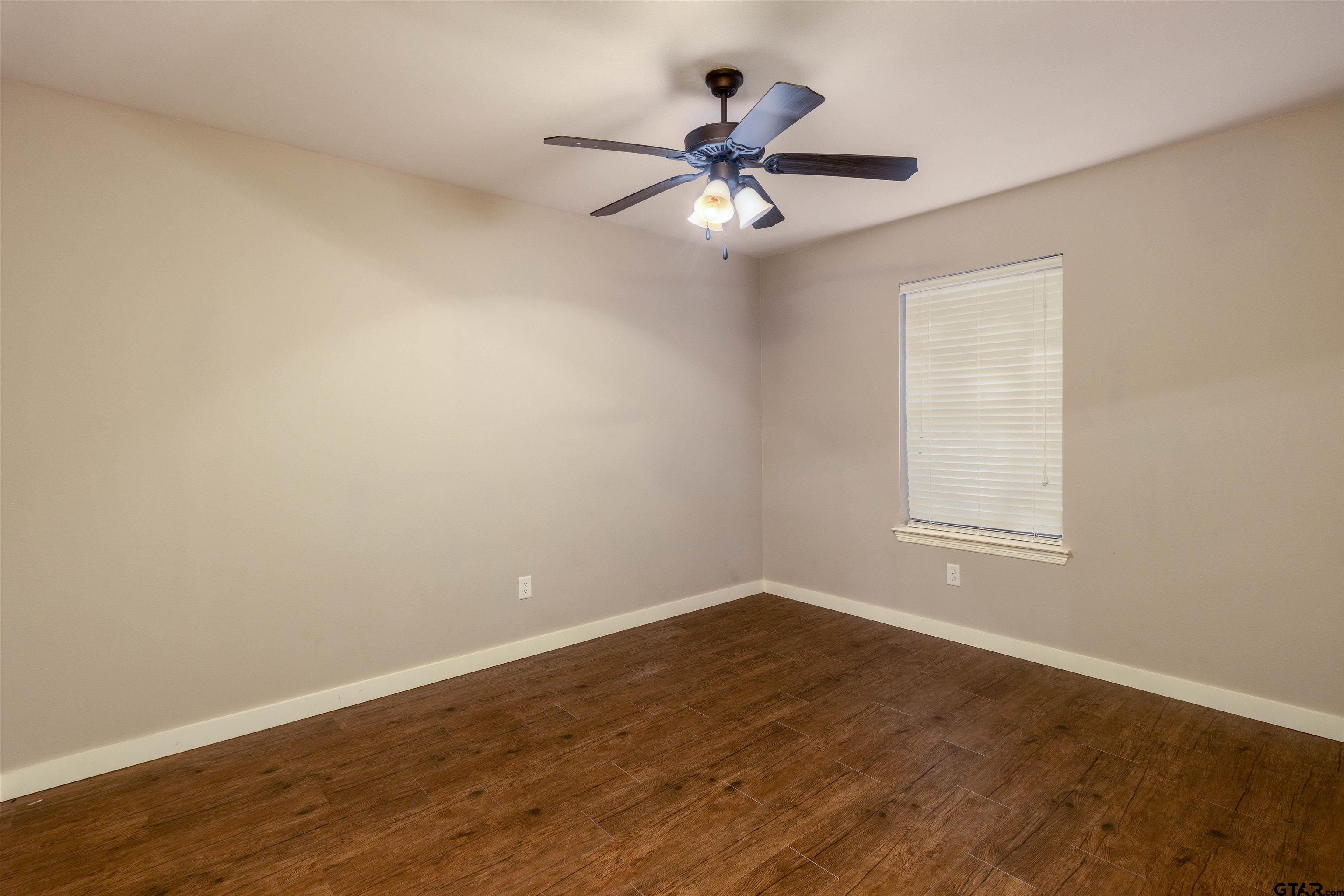 5106 Shiloh Ridge Drive Tyler, TX 75703 - Photo 12 of 19 a view of a room with wooden floor and windows