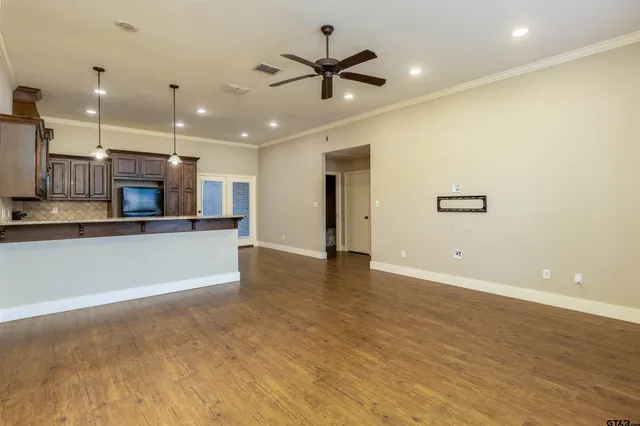 a view of a kitchen with a sink and a refrigerator