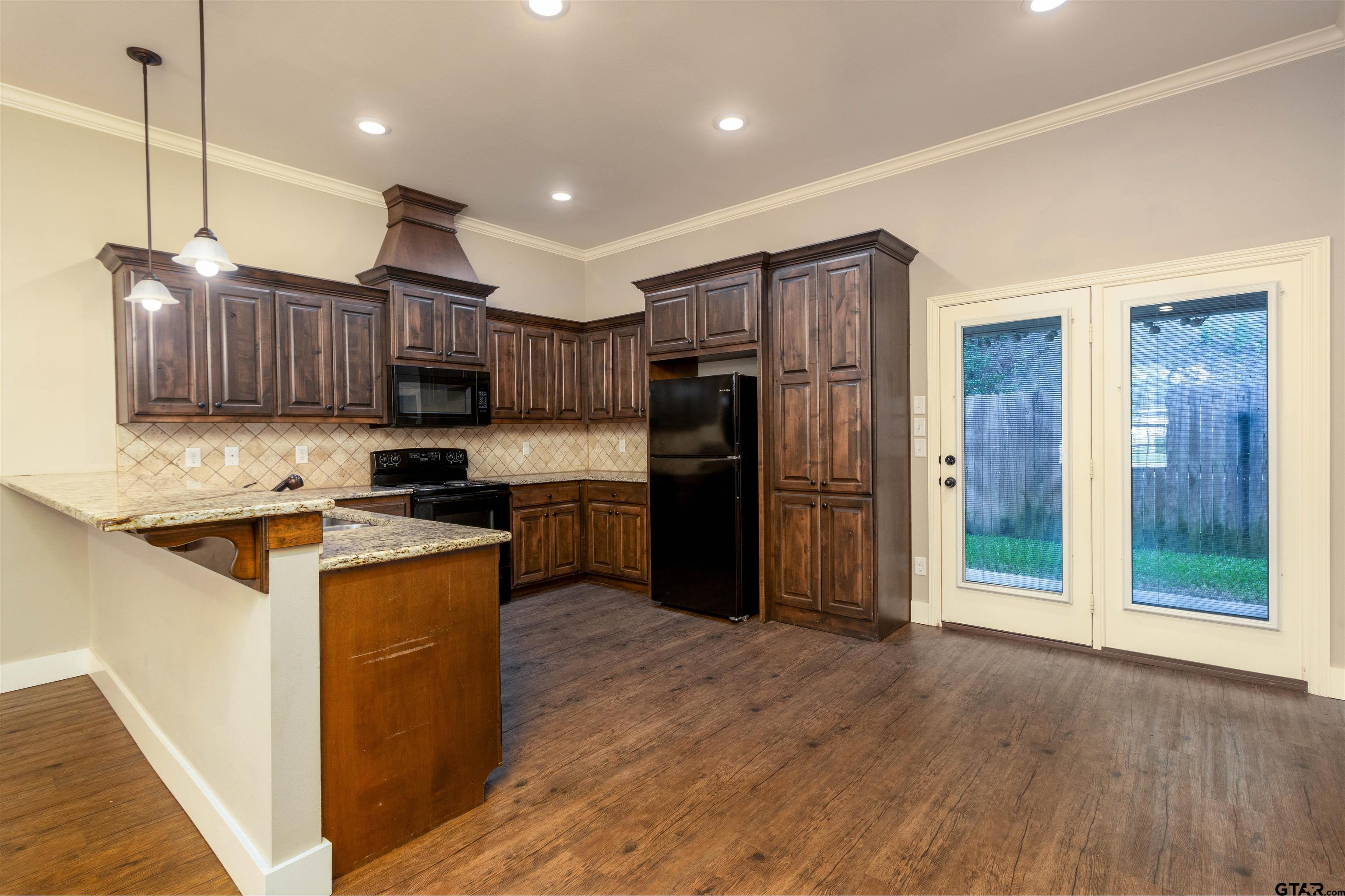 5106 Shiloh Ridge Drive Tyler, TX 75703 - Photo 6 of 19 a kitchen with stainless steel appliances granite countertop a refrigerator a sink a stove and a wooden floors