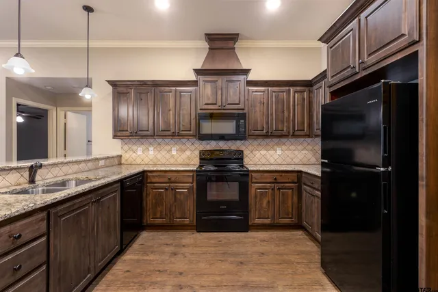 a kitchen with stainless steel appliances granite countertop a stove and a refrigerator