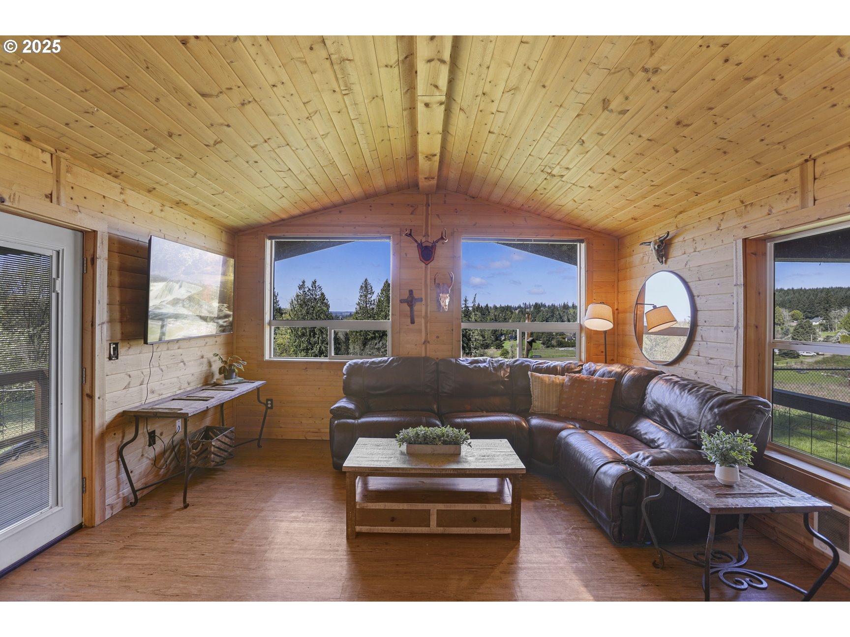 26748 Wonderly Road Rainier, OR 97048 - Photo 6 of 27 a living room with furniture a fireplace and a large window