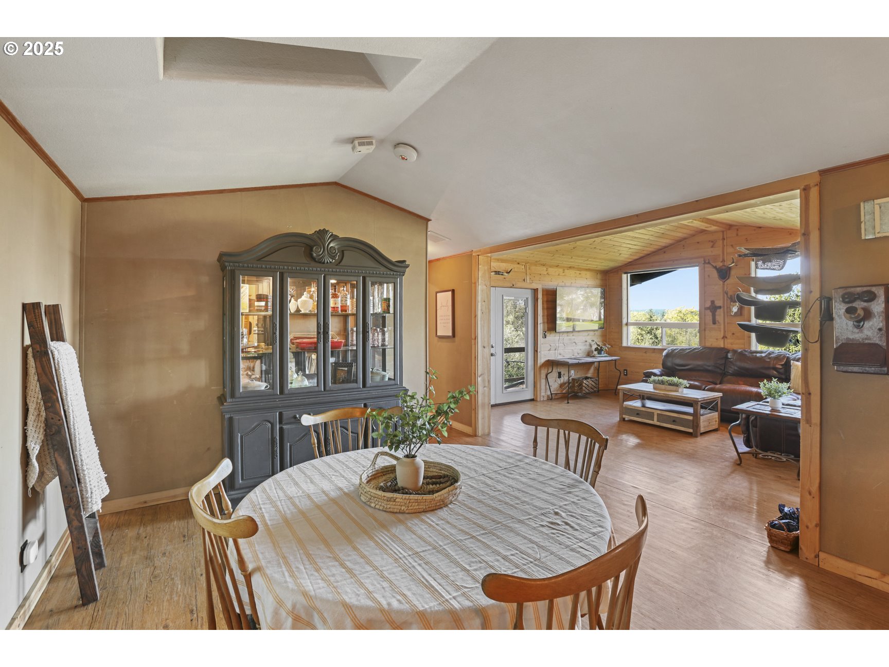26748 Wonderly Road Rainier, OR 97048 - Photo 9 of 27 a dining room with furniture large windows and a chandelier