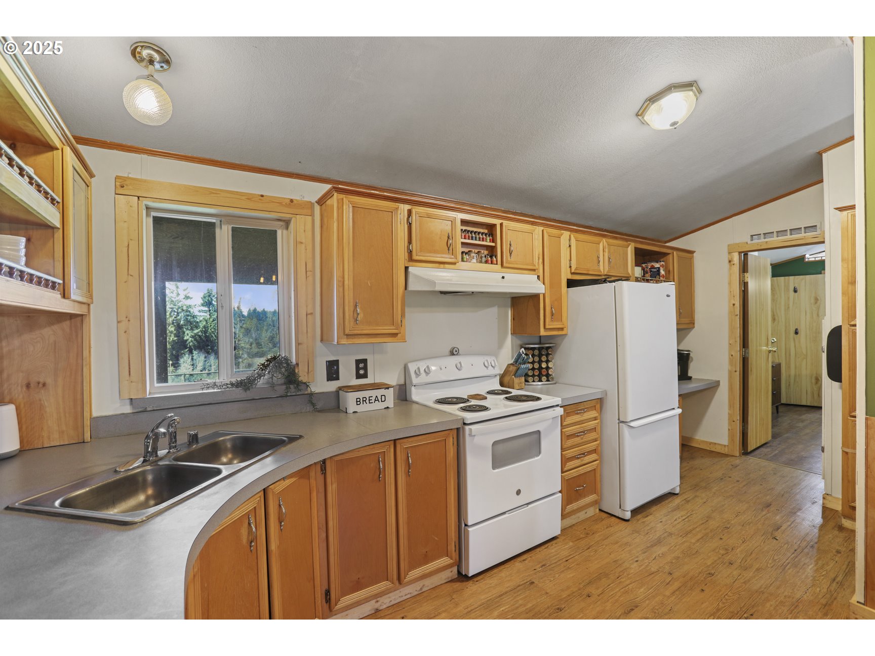 26748 Wonderly Road Rainier, OR 97048 - Photo 10 of 27 a kitchen with a sink stove and refrigerator