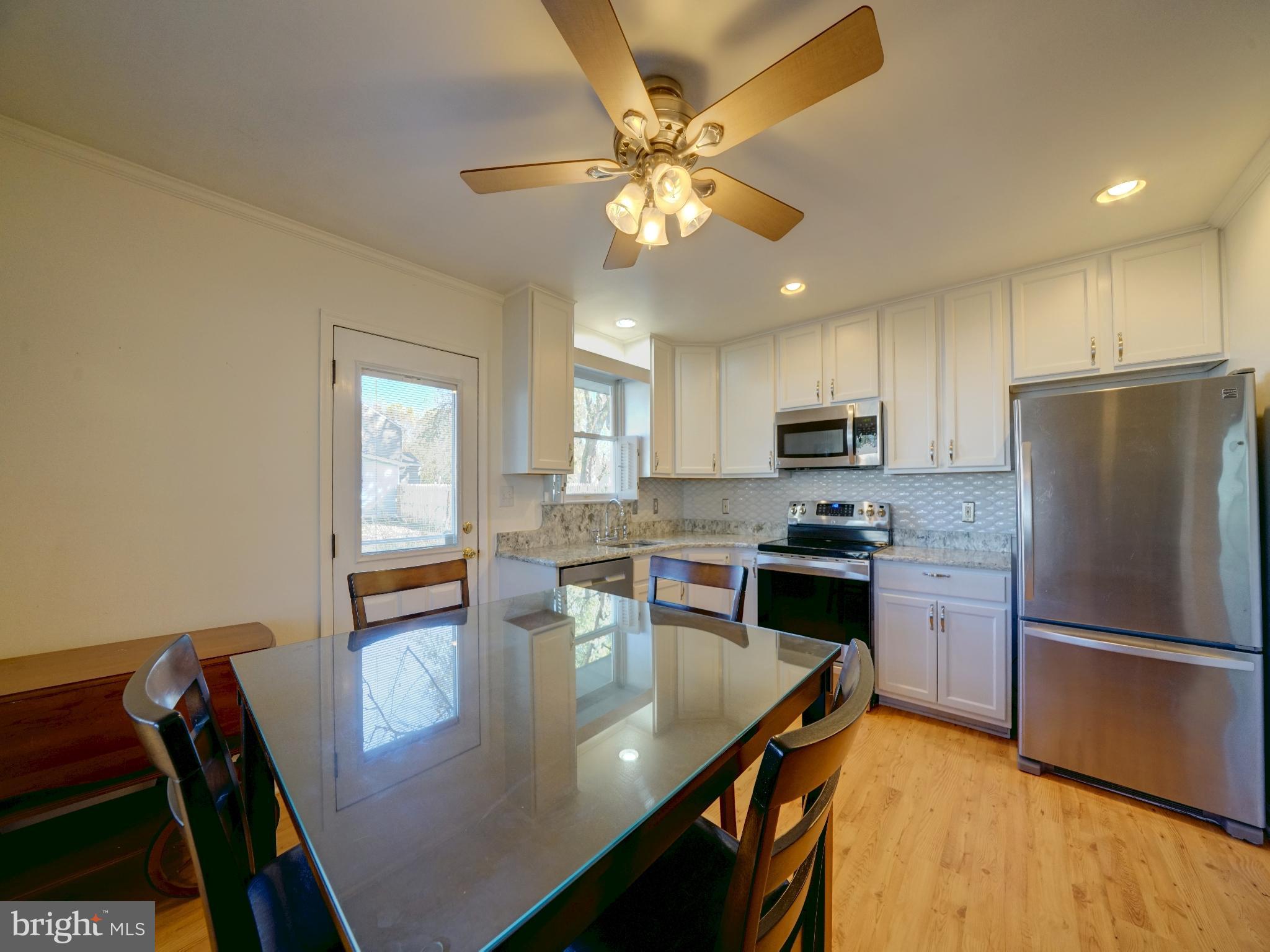 7819 Appletree Road Pasadena, MD 21122 - Photo 14 of 59 Modern kitchen with sleek finishes.