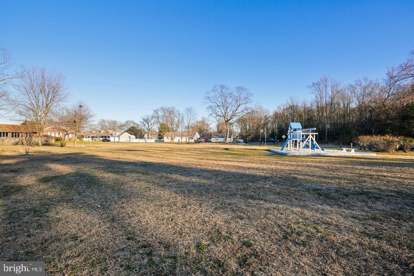 7819 Appletree Road Pasadena, MD 21122 - Photo 55 of 59 Spacious yard with playground and clear skies.