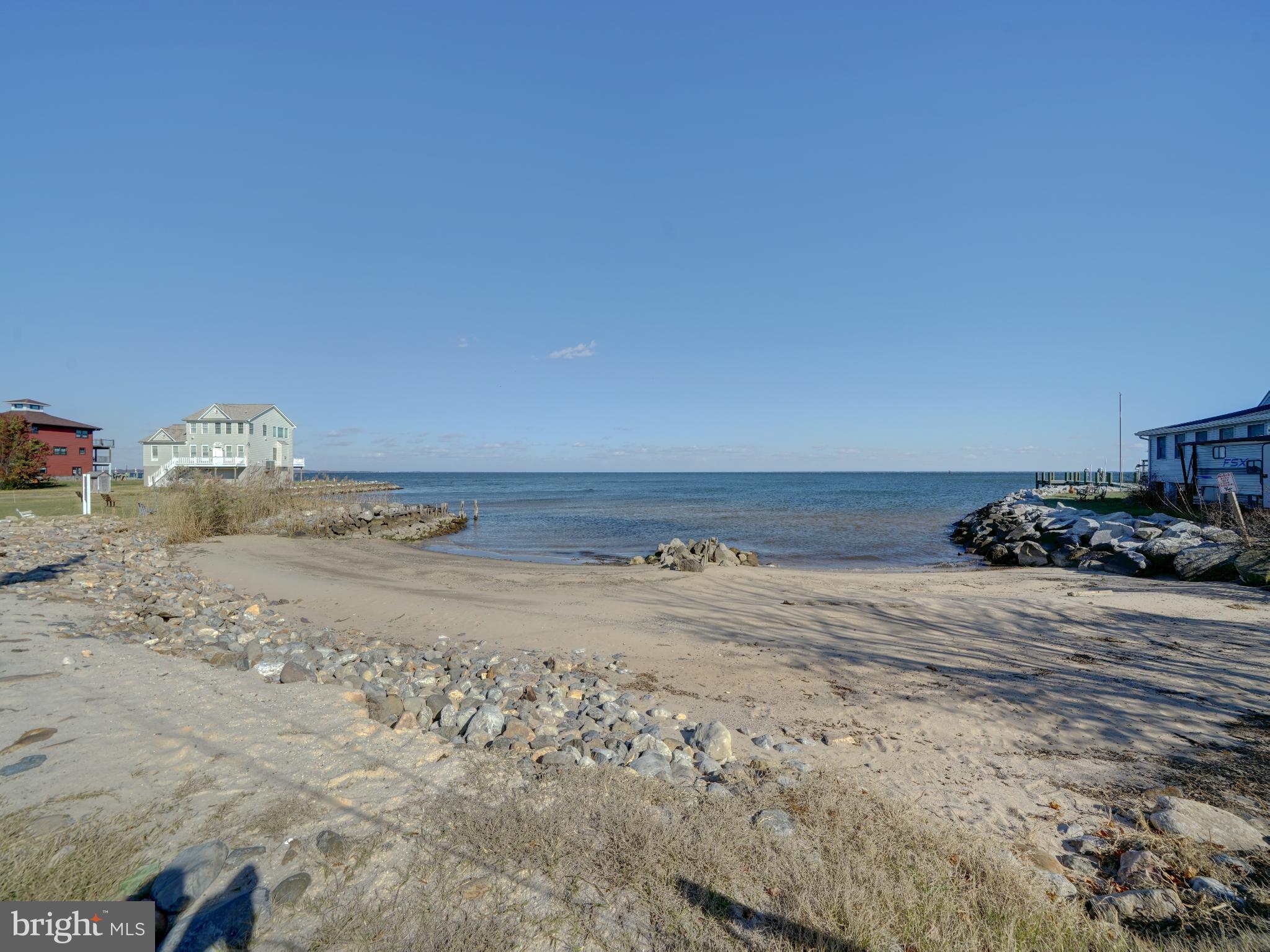 7819 Appletree Road Pasadena, MD 21122 - Photo 57 of 59 Serene beachfront with tranquil waters.